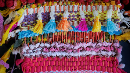 Fototapeta premium Close up vivid colorful of hand woven fabric texture, linen, cotton. Fabric texture, woven rope texture pattern. Knitted fabric background, style rug surface, abstract design