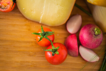 Bosnian traditional cheese served on a wooden container with peppers, parade and onions isolated on a white background