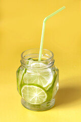 water with lime wedges in a glass jar with shade