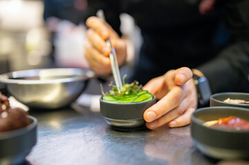 Chef cooking vegetables salad on restaurant kitchen