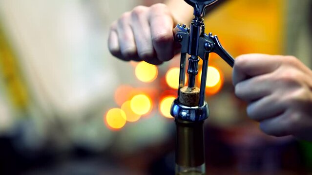 Opening  bottle of wine with corkscrew