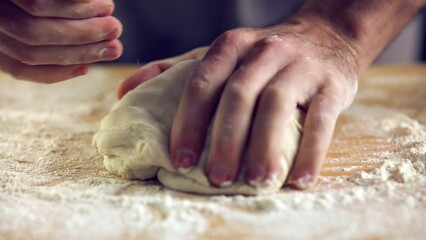 Hands kneading dough for homemade bread or pastries