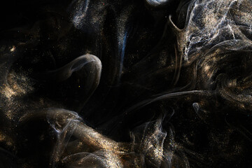 Black gold abstract ocean background. Splashes and waves of sparkling paint under water, clouds of interstellar smoke in motion © amixstudio