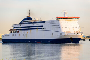 Ro-ro cargo ship leaving the port of Rotterdam at sunset