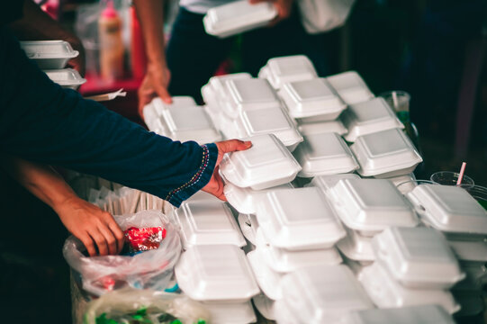 Poor people's hands share free food from volunteers who donate food : concept of feeding, sharing food
