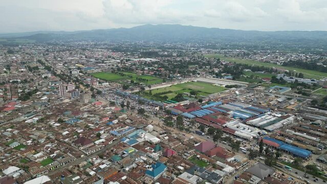 Aerial view of Mbeya city in Tanzania, Africa. Town is located in south west of Tanzania. Narrow highland valley surrounded by a bowl of high mountains.