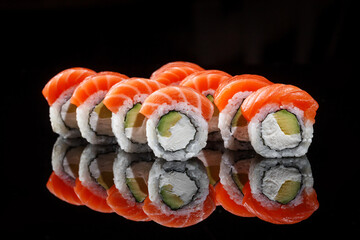 Philadelphia sushi rolls on black background 