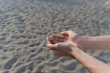 Man empty hands open up on desert background. No water, hot summer