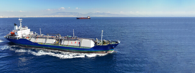 Aerial drone ultra wide top view photo of industrial liquified LPG gas tanker cruising near gas...