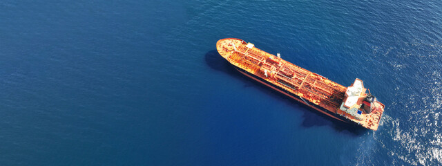 Aerial drone ultra wide panoramic photo of industrial crude oil - fuel tanker ship anchored in deep...