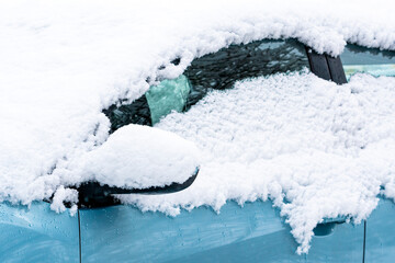 Close-up of snow covered car wing mirror