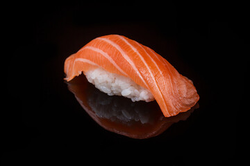 classic sushi with salmon on a black background 