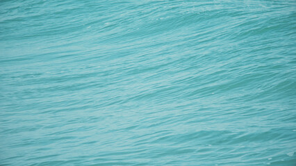 Blue background texture of the sea water. The surface of the sea.