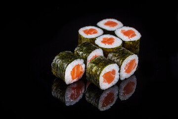 sushi maki roll wrapped in nori seaweed with salmon 
