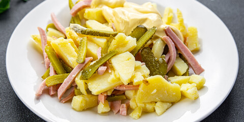 potato salad, gherkin, sausage, mayonnaise fresh ready to eat meal food snack on the table copy space food background rustic top view