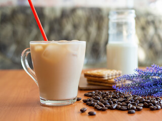 a cup of coffee and some cookies on a table, wall on background