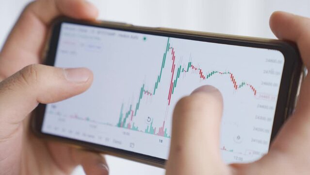 Thoughtful and experienced hands analyzing charts on the stock market.
Man analyzing financial data stock market price, checking online trading platform app.
