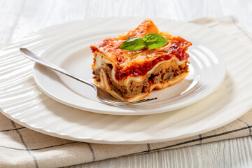 portion of Lasagna on white plate, top view