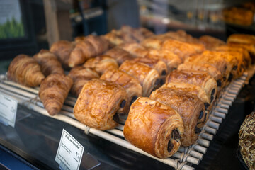 étal de pains au chocolat dans une vitrine de boulangerie