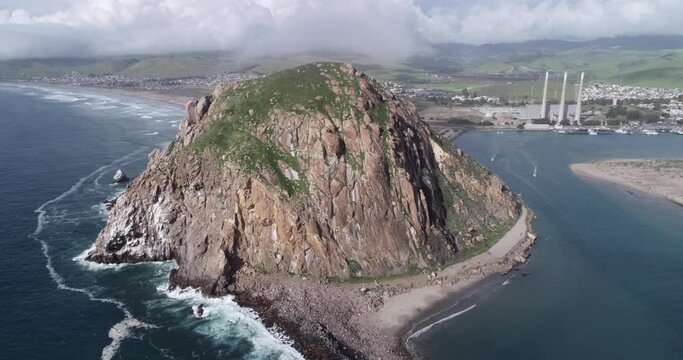 Morro Rock in Morro Bay. California, USA. Ancient volcanic mound at the end of Morro Rock Beach