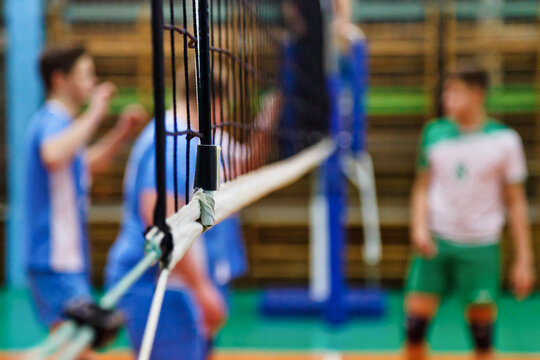 Sports image background for team volleyball games: volleyball game and net in an old school sport gym. Concept of getting sport, healthy lifestyle and team success. Copy advertising text space