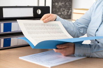 Woman hands checking documents on folders