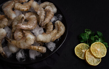 Frozen raw shrimp vannamey, on wooden skewers, ice cubes and lime slices, top view, no people,