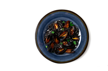 Spaghetti with black squid, black pasta, with boiled mussels, on a black plate, with parsley and parmesan cheese, close-up, selective focus, no people,