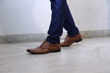 Male walking in shoes. close up of Men's fashion brown shoes classic design. 