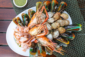 Seafood prawns, prawns, mussels, clams on plate and dark background/cooked food