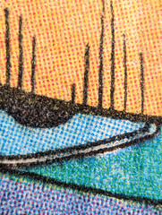 Macro view of the dot printing pattern on an old comic book page with background texture of colorful abstract shapes