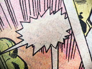 Closeup photo of a vintage comic book page with an empty speech bubble and colorful dot print pattern old paper background