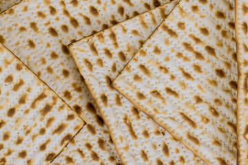 Passover matzoh jewish holiday bread over wooden table.