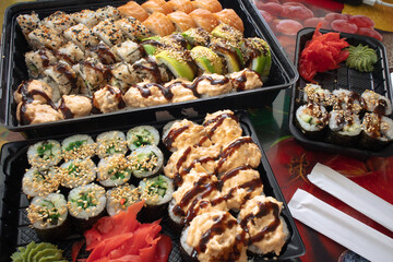 Lots of sushi rolls on the table. Sushi set with a variety of rolls. Delicious sushi rolls