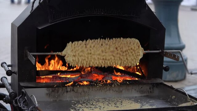 Cooking Sakotis in Vilnius, Lithuania. It is traditional spit cake