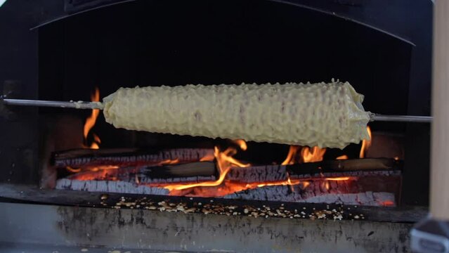 Cooking Sakotis in Vilnius, Lithuania. It is traditional spit cake