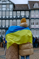 Support of Ukraine in Europe. Two women with Ukrainian flag at demonstration.