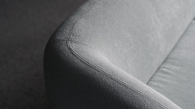 Blue sofa in a dark room. Close-up showing the details of a sofa