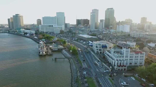 New Orleans Cityscape during French Quarters Music Festival, Louisiana. Steamboat Natchez Mississippi River City Skyline in Background. Sunset Light