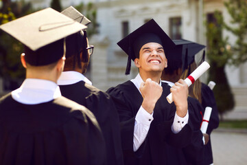 I did it. Happily excited male student clenched his fist with joy during graduation ceremony. Guy...