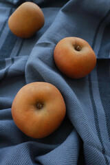 Tasty ripe apples on blue cloth