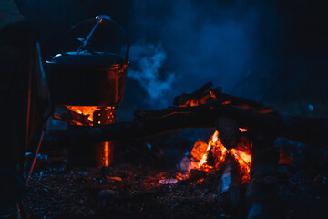 Cooking food with a campfire at night outdoors