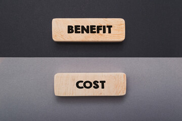 Wooden tablets with words Benefit and Costs upper view