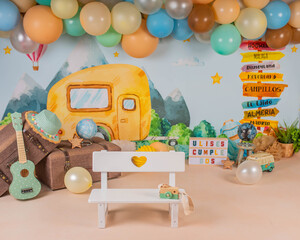 first year birthday photo session in a photo studio with a traveling theme