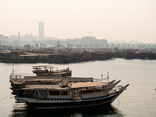 Misty view of boats in the bay in the city of Doha, capital of Qatar
