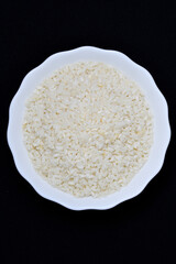 Peeled rice in a white plate. Food rice. Dry rice.