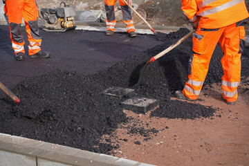 Asphalting of a new road on a construction site housing construc