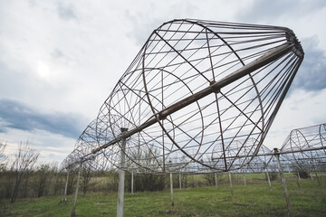 Radio astronomy observatory radio telescope construction in the fields in early spring in cloudy weather, T-shaped radio telescope in the Kharkiv region