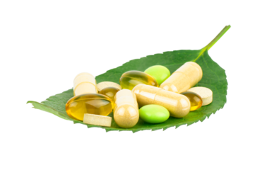 Vitamin, dietary supplement and herbal pills on green leaf isolated on transparent background, healthcare concept
