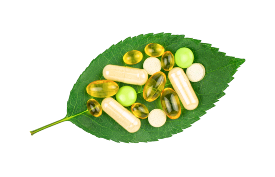 Variety of dietary supplement pills on fresh green leaf isolated on transparent background, top view. Alternative medicine concept